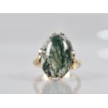 A 9ct Gold Mounted Moss Agate Ring, Cabochon Stone Measuring 18mm by 13mm Set in Split Claws,