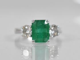 An 18ct White Gold, Diamond and Emerald Three Stone Ring, Central Rectangular Step Cut Emerald