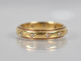 An 18ct Gold and Diamond Ring, Eleven Round Cut Diamonds In Recessed Bead Bright Lozenge Setting,