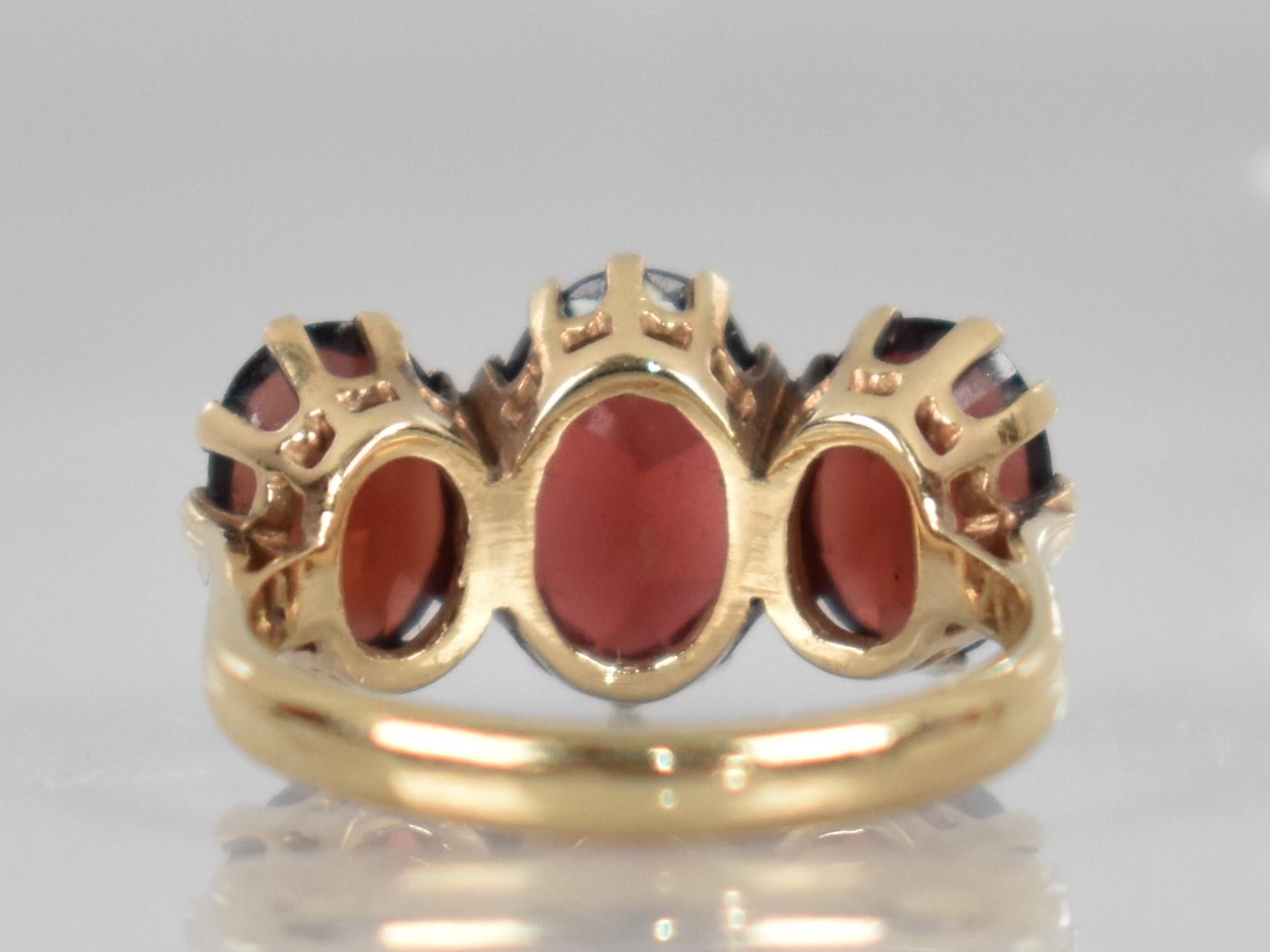 A 9ct Gold and Garnet Dress Ring, Central Oval Cut Stone Measuring 9.9mm by 6.5mm, Claw and - Image 2 of 3