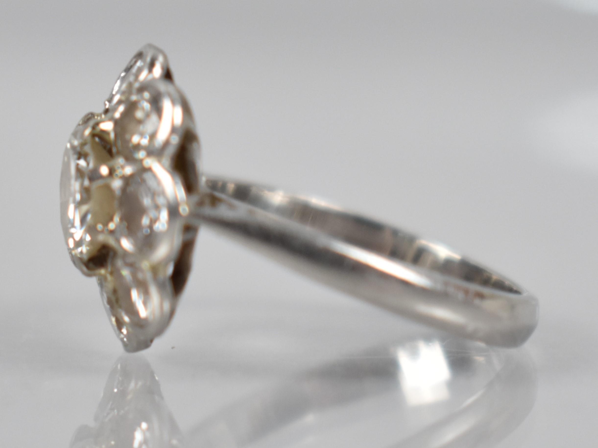 A Platinum and Diamond Daisy Cluster Ring (At Fault), Central Round Cut Diamond Measuring 6.31mm - Image 14 of 14