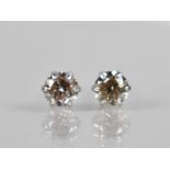 A Pair of Diamond and Platinum Stud Earrings, Round Brilliant Cut Stones Measuring 0.30ct Each (0.