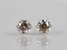 A Pair of Diamond and Platinum Stud Earrings, Round Brilliant Cut Stones Measuring 0.30ct Each (0.
