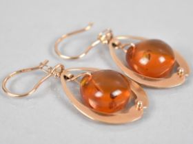 A Pair of Russian 14ct Rose Gold and Amber Earrings, Ovoid Amber Drops Measuring 12.9mm by 14.5mm