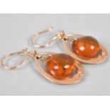 A Pair of Russian 14ct Rose Gold and Amber Earrings, Ovoid Amber Drops Measuring 12.9mm by 14.5mm