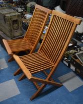A Pair of Teak Folding Patio Chairs