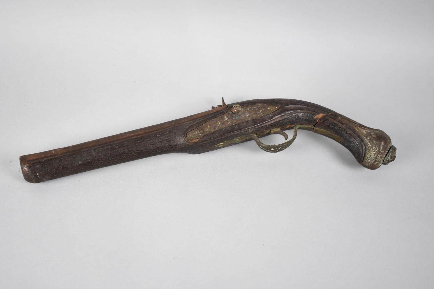 A Vintage Reproduction Flintlock Pistol with Carved Wooden Brass Mounted Handle