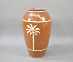 A Large Terracotta Glazed Jar Decorated with Palm Trees, 64cms High