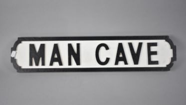 A Modern Painted Wooden Sign in the Form of a Victorian Street Sign, 'Man Cave', 64x14cms