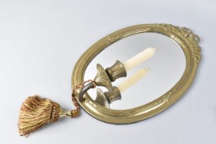 A Modern Brass Framed Oval Wall Mirror with Candle Holder and Tassel, 35cms High