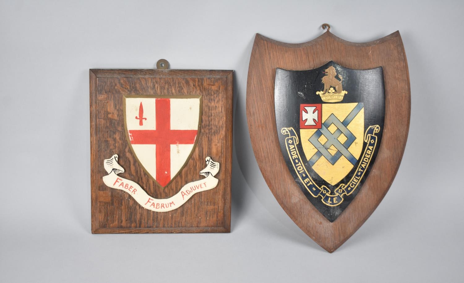 Two Mid 20th Century Wall Hanging Heraldic Shields, Help Yourself and Heaven with Help You, and Iron