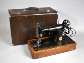 A Singer Electric Sewing Machine in Case with Foot Pedal