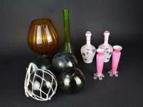 A Collection of Various Coloured Glass to Comprise Four Green Glass Floats, Amber Glass Pedestal