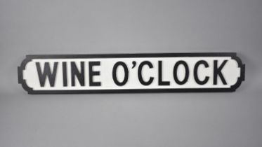 A Modern Painted Wooden Sign in the Form of a Victorian Street Sign 'Wine O'Clock' 78cms by 14cms