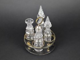 A 19th Century Papier Mache Four Bottle Cruet Stand Containing Four Cut Glass Bottles, One with