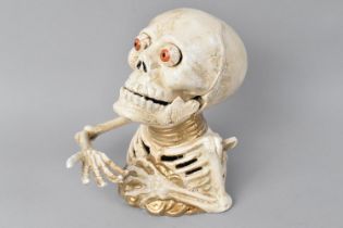 A Reproduction Cold Painted Cast Metal Novelty Childs Money Bank in the Form of a Skeleton, 17cms