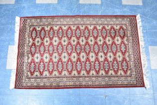 A Modern Patterned Hearth Rug on Red Ground, 155x95cm