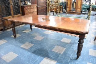 A Late Victorian/Edwardian Mahogany Wind Out Dining Table with Two Extra Leaves on Turned Supports