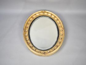 A 19th Century Oval Wall Hanging Mirror with Applied Ball Decoration, 77cms High and 65cms Wide