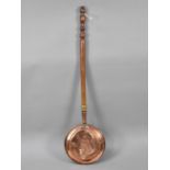 A Copper Bed Pan with Turned Wooden Handle