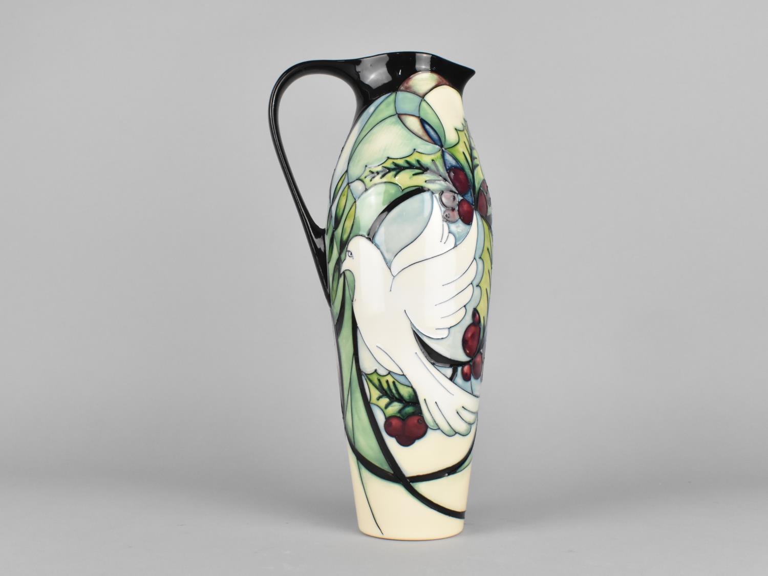 A Moorcroft Ewer, Doves and Holly Pattern, 2015, 27cm high
