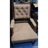 An Edwardian oak and Upholstery Button Back Armchair with Carved top and Spindle Supports Raised