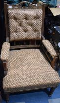 An Edwardian oak and Upholstery Button Back Armchair with Carved top and Spindle Supports Raised