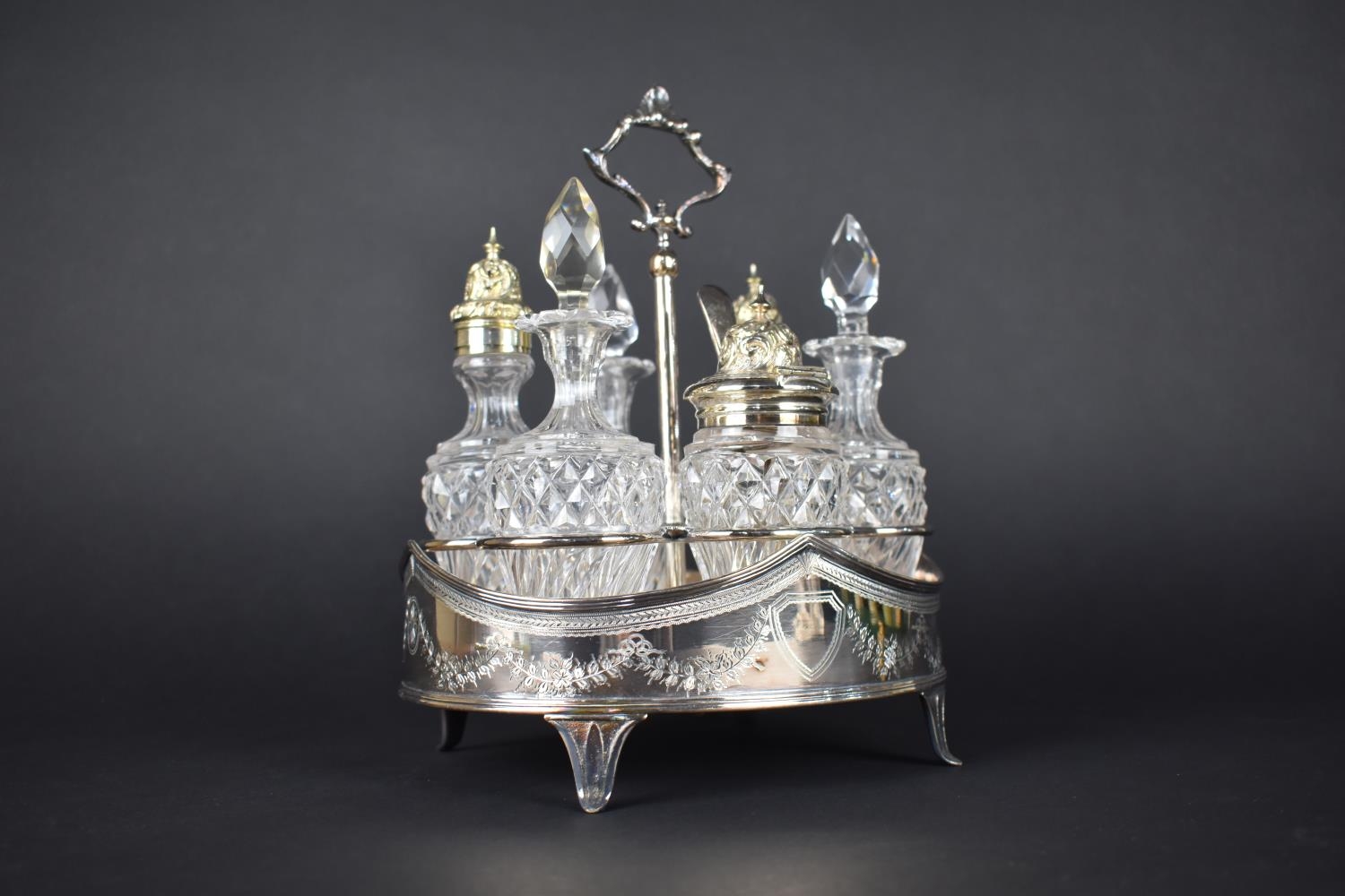 A Glass and Silver Plate Six Bottle Cruet on Silver Plated Stand