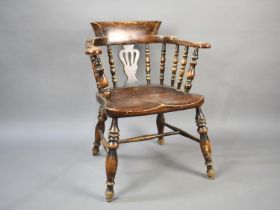 An Early 20th Century Smokers Bow Tub Armchair with Spindle and Vase Pierced Back on Turned Supports