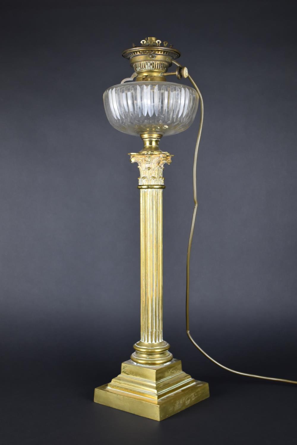 A Tall Brass Oil Lamp Having Plain Cut Glass Reservoir Raised on a Corinthian Column with Tapering