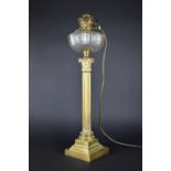 A Tall Brass Oil Lamp Having Plain Cut Glass Reservoir Raised on a Corinthian Column with Tapering