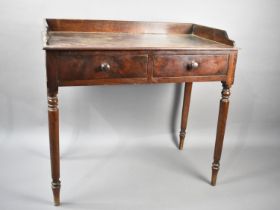 A 19th Century Mahogany Galleried Side Table with Two Single Drawers on Turned Supports, 89x46x82cms