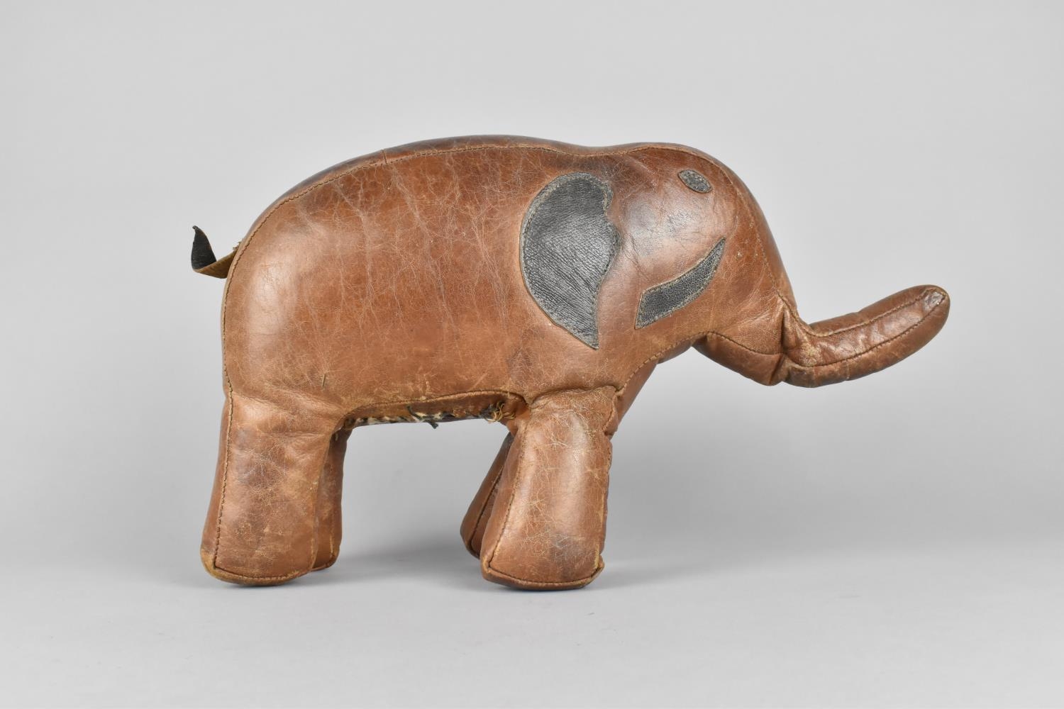 A Small Vintage Brown Stitched Leather Covered Footstool in the Form of an Elephant, in the Manner