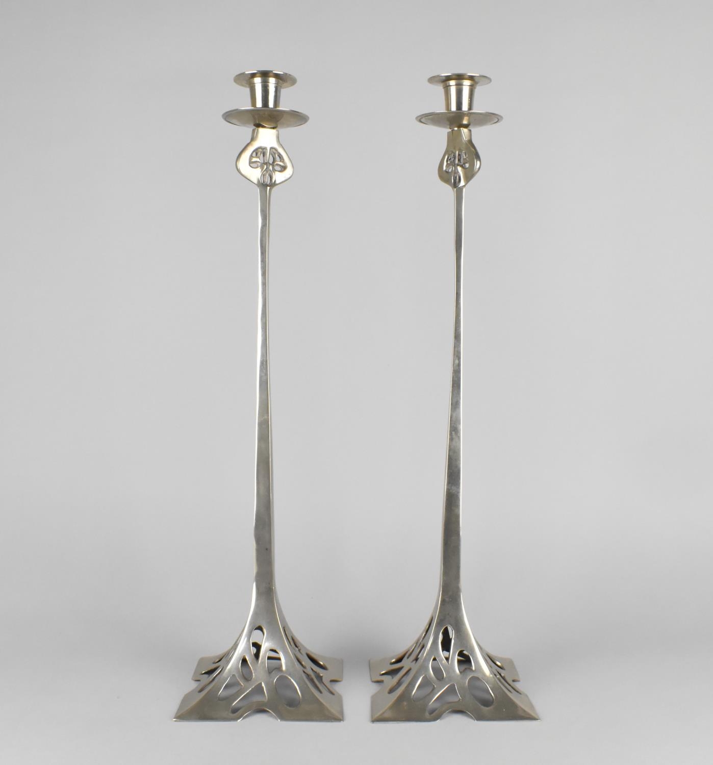 A Pair of Arts and Crafts Style Silver Plated Candlesticks with Flared Square Pierced Bases having