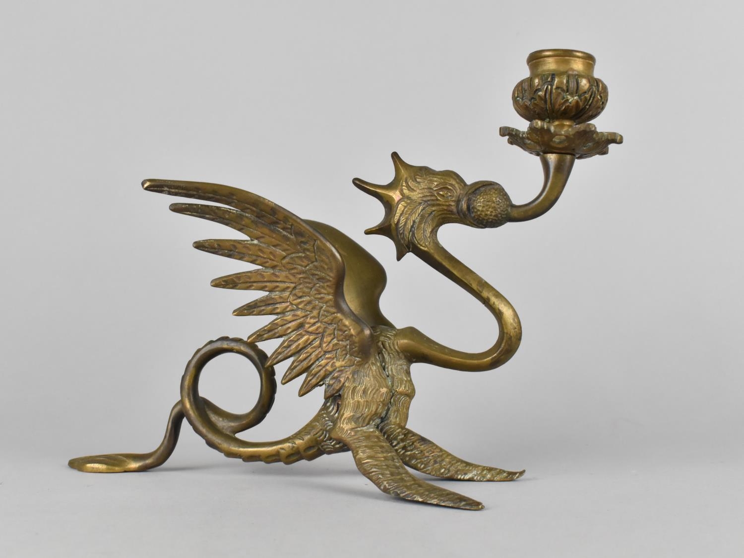 An Ornate Brass Candlestick Modelled as a Winged Griffin, 16cms High