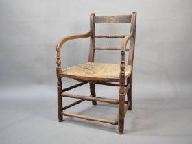 An Early 20th Century Rush Seated Oak Framed Chair