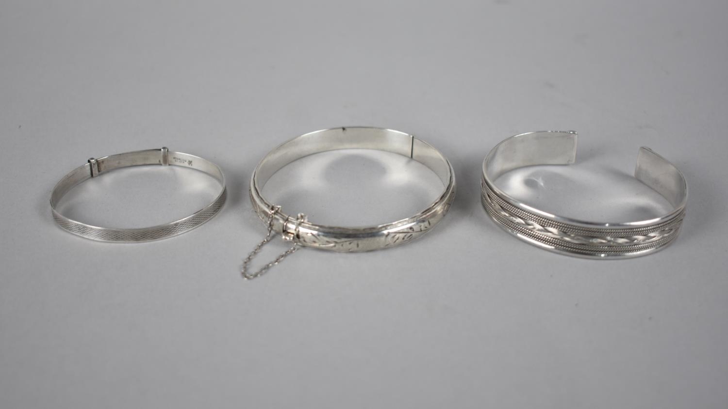Three Silver Bracelets to include Childs Bangle, Eastern Cuff and Vintaged Hinged Bangle with