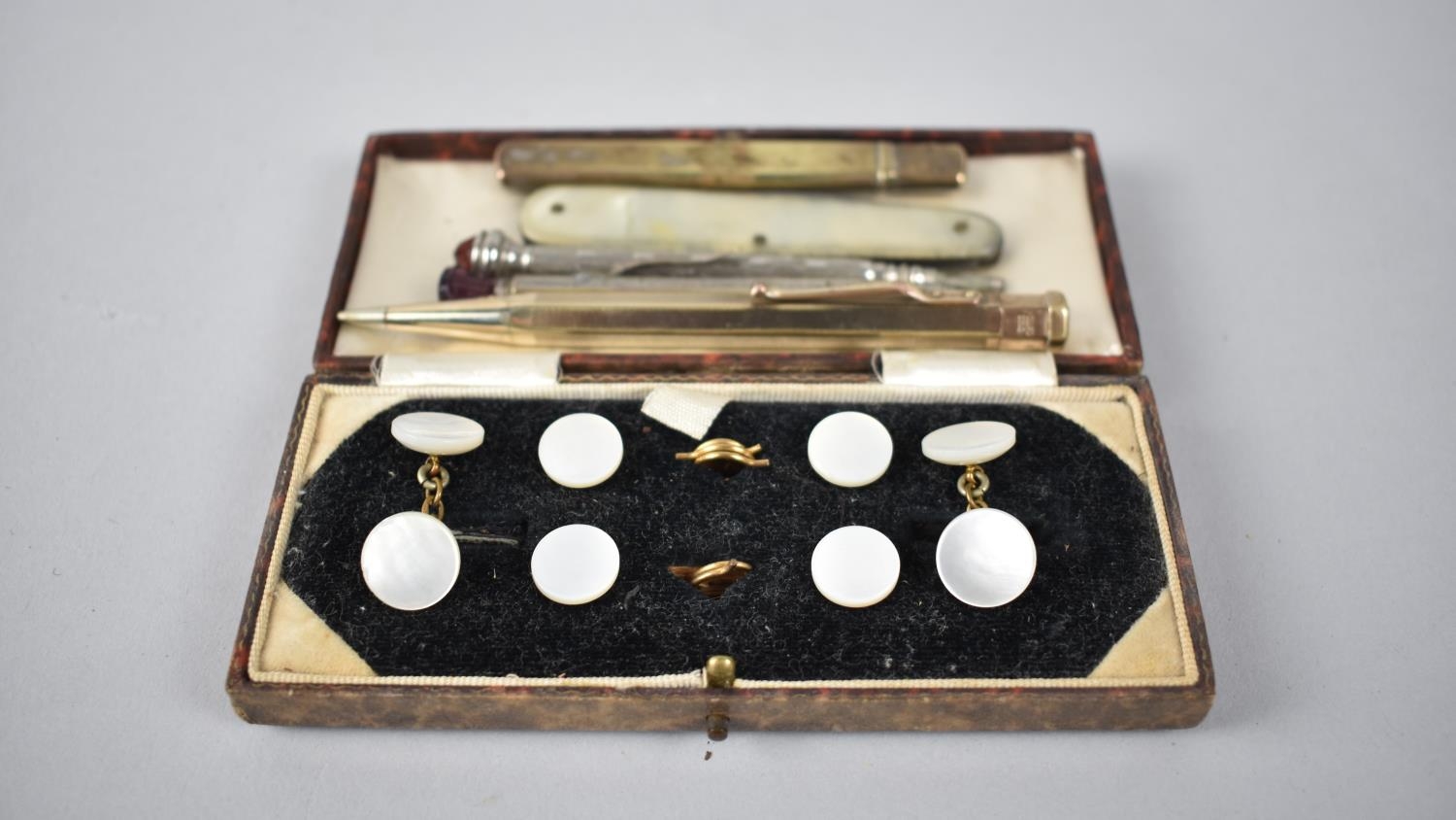 A Cased Set of Mother of Pearl Gentleman's Studs together with Three Propelling Pencils, Mother of