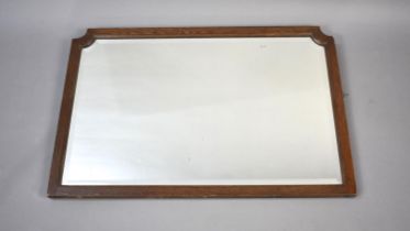 An Oak Framed Bevelled Edge Wall Mirror with Canted Corners
