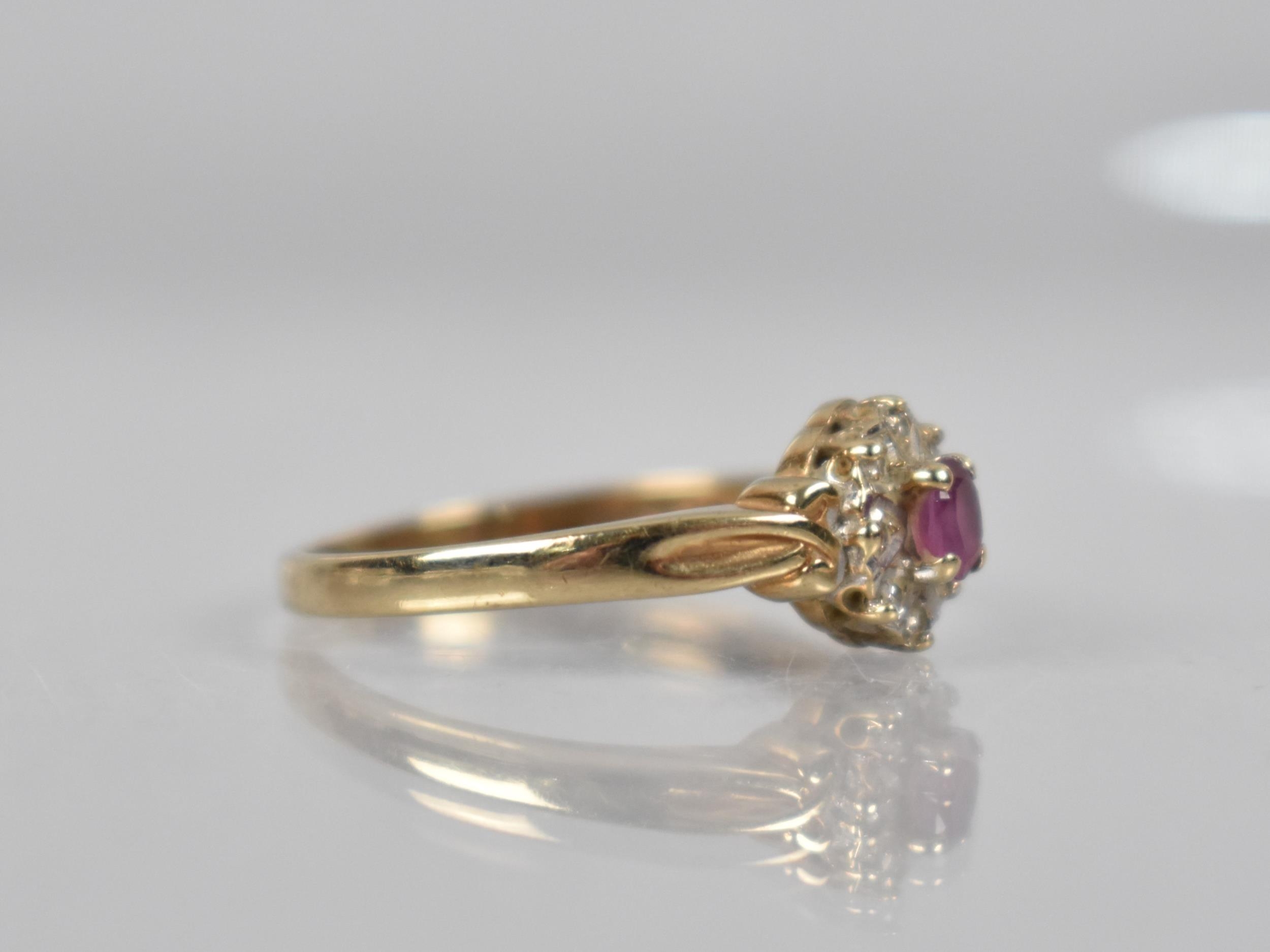 A 9ct Gold, Diamond and Ruby Cluster Ring, Oval Cut Ruby Measuring 3.9mm by 2.8mm Set in Four - Image 2 of 2