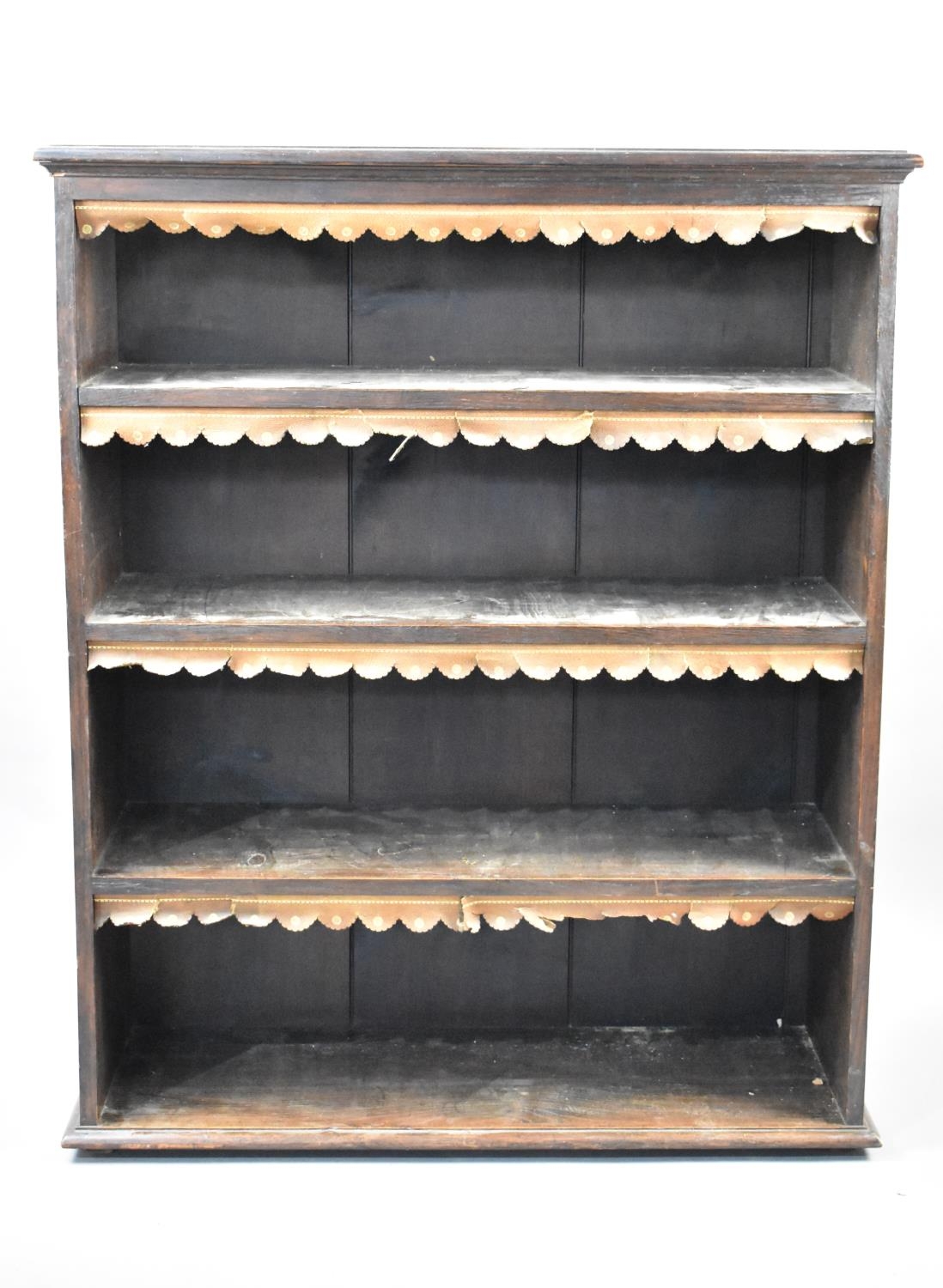 An Early 20th Century Oak Four Shelf Bookcase with Tooled Leather Fringes and Carved Decoration to