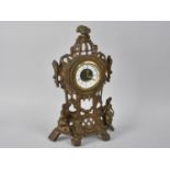 An Ornate Cast and Pierced Brass Clock, 36cms High