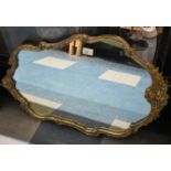 An Ornate Framed Wall Mirror with Scrolled and Floral Decoration