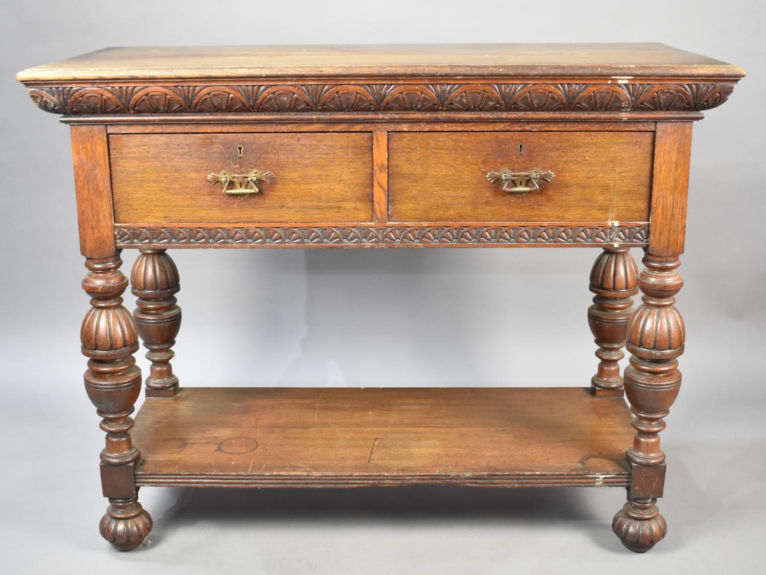 An Oak Side Table or Buffet Having Two Short Drawers on Folded Supports with Stretcher Shelf and