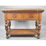 An Oak Side Table or Buffet Having Two Short Drawers on Folded Supports with Stretcher Shelf and