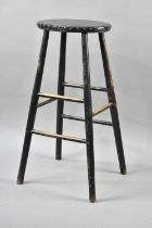 A Vintage Black Painted Stool with Leather Studded Top, 75cms High