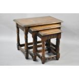 A Mid 20th Century Oak Nest of Three Tables with Turned Supports, Largest Table 61x36.5x47cms High