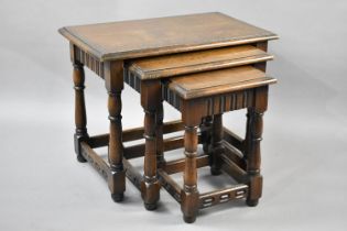 A Mid 20th Century Oak Nest of Three Tables with Turned Supports, Largest Table 61x36.5x47cms High