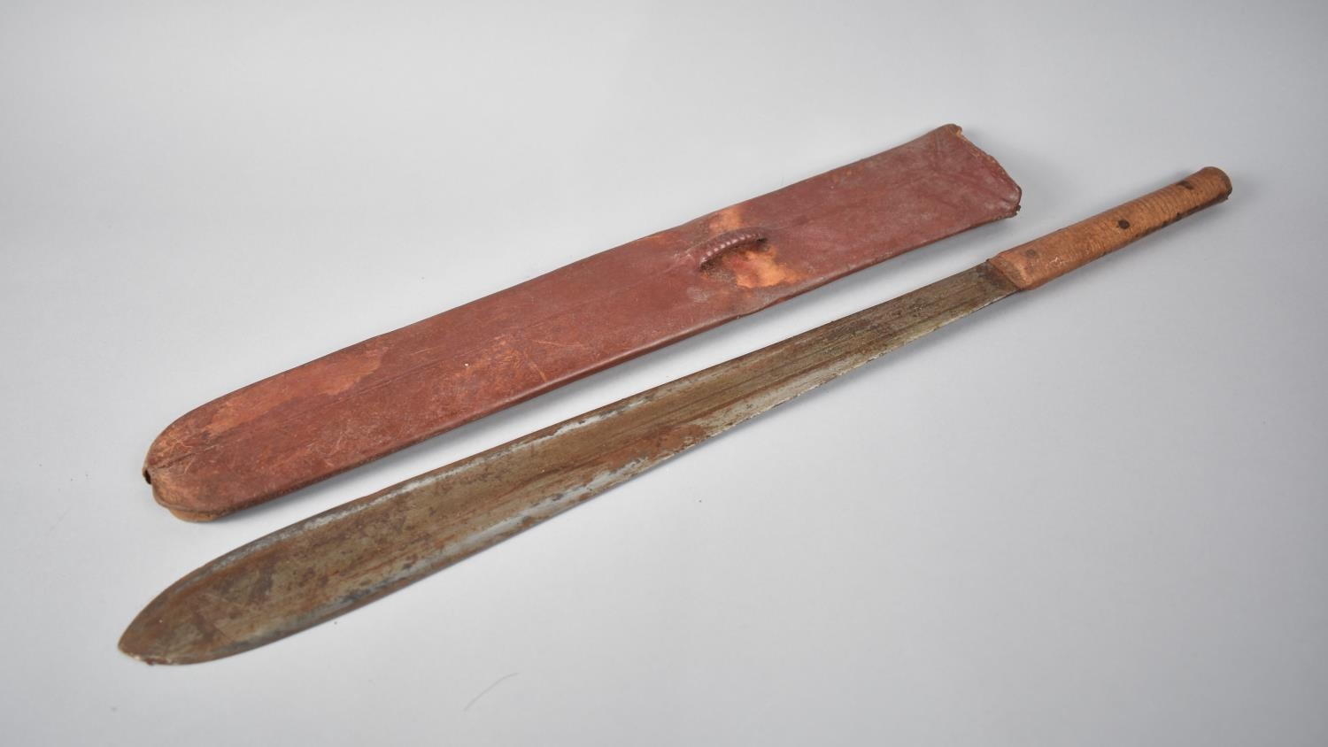 A Vintage Wooden Handled Maasai Simi in Animal Skin Scabbard