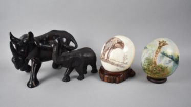 Two Decorated Ostrich Eggs together with a Wooden Rhino and an Elephant Ornament (Some Condition